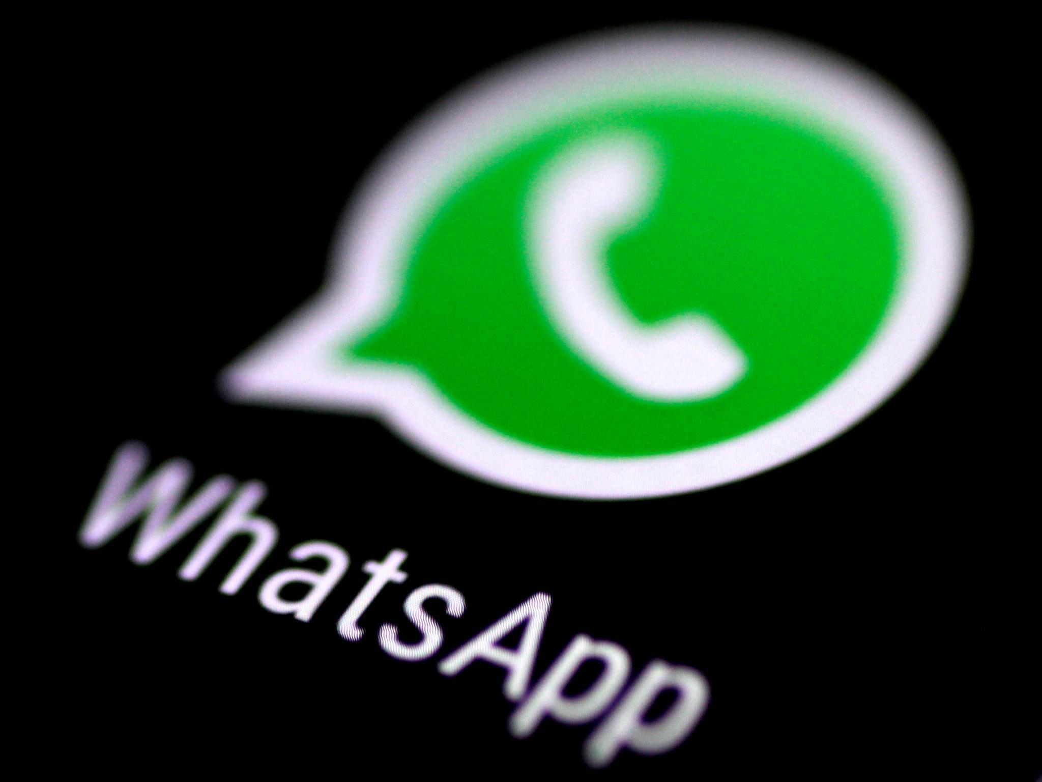 WhatsApp logo: a white telephone handset inside a green speech bubble on a black screen